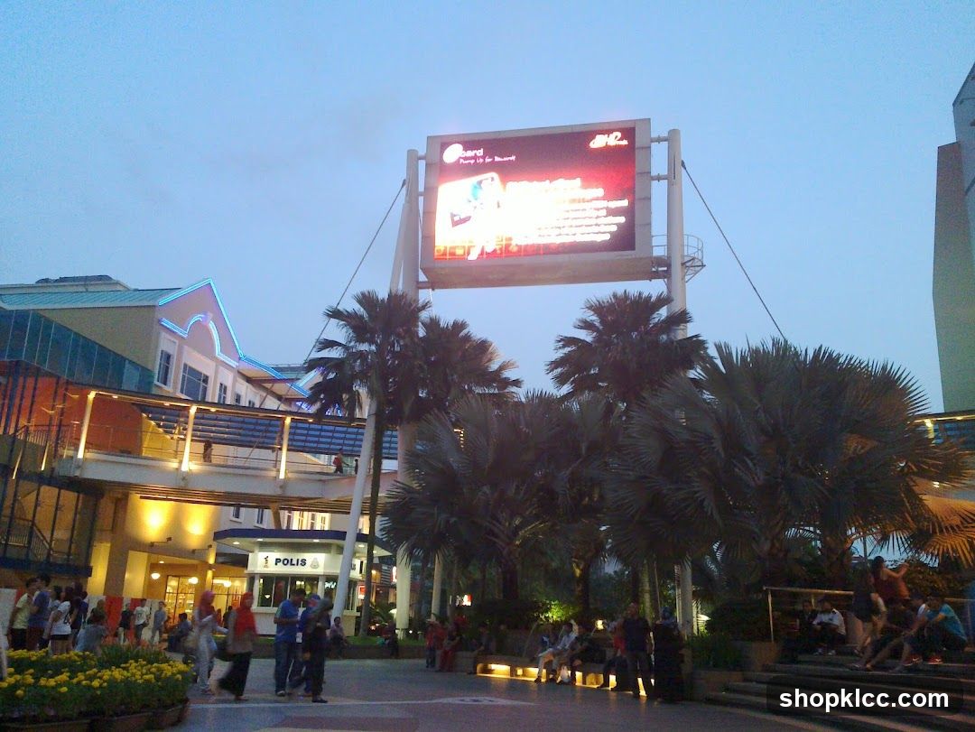 Evening scene with palm trees and digital billboard