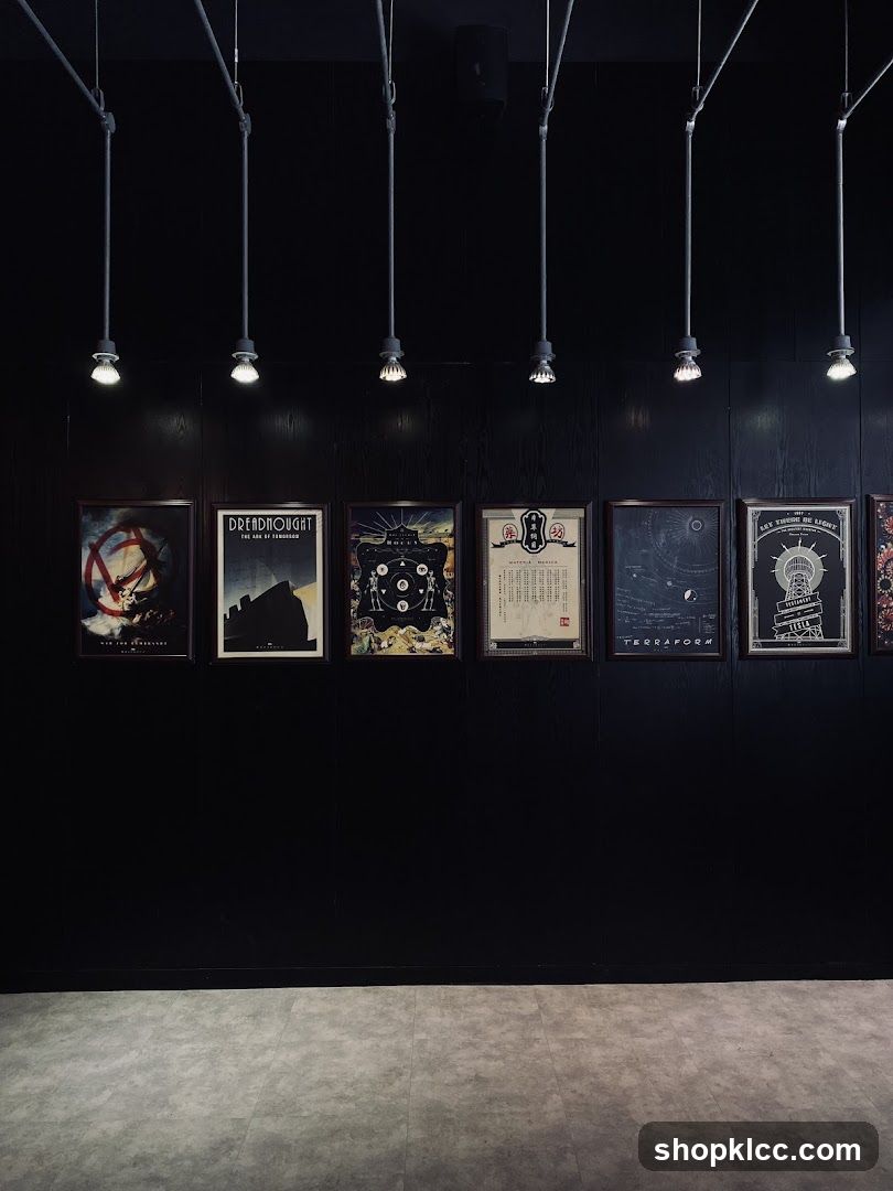 Framed posters on a black wall