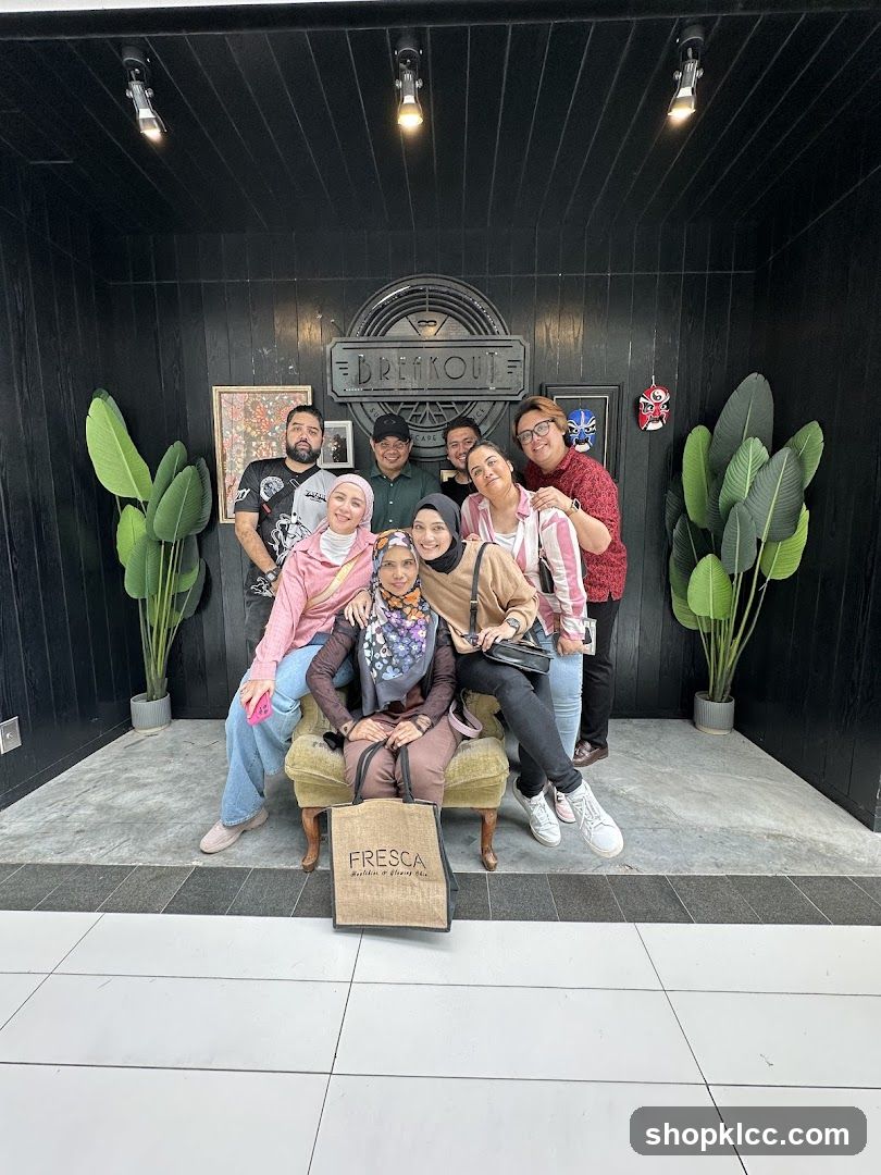 Group posing in front of Breakout signage