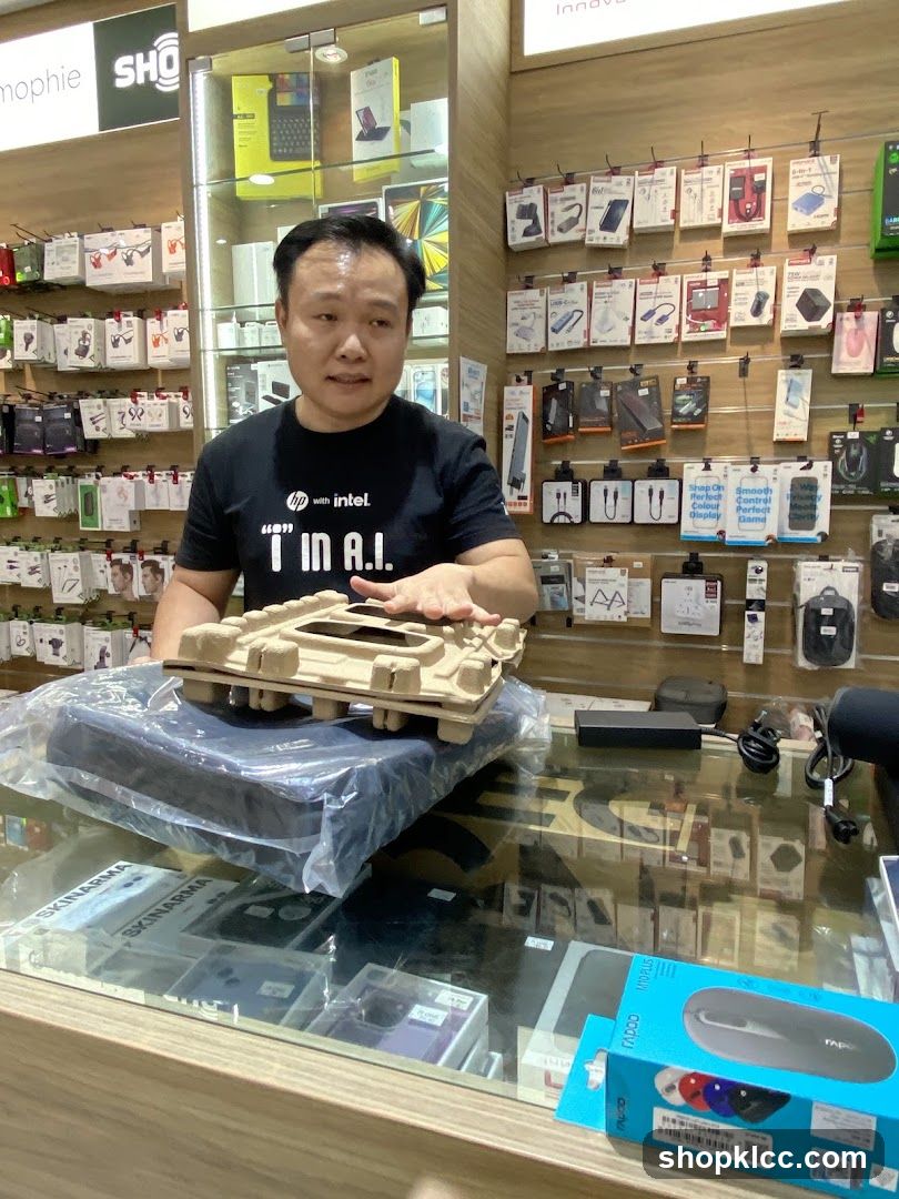Man holding a laptop in a store