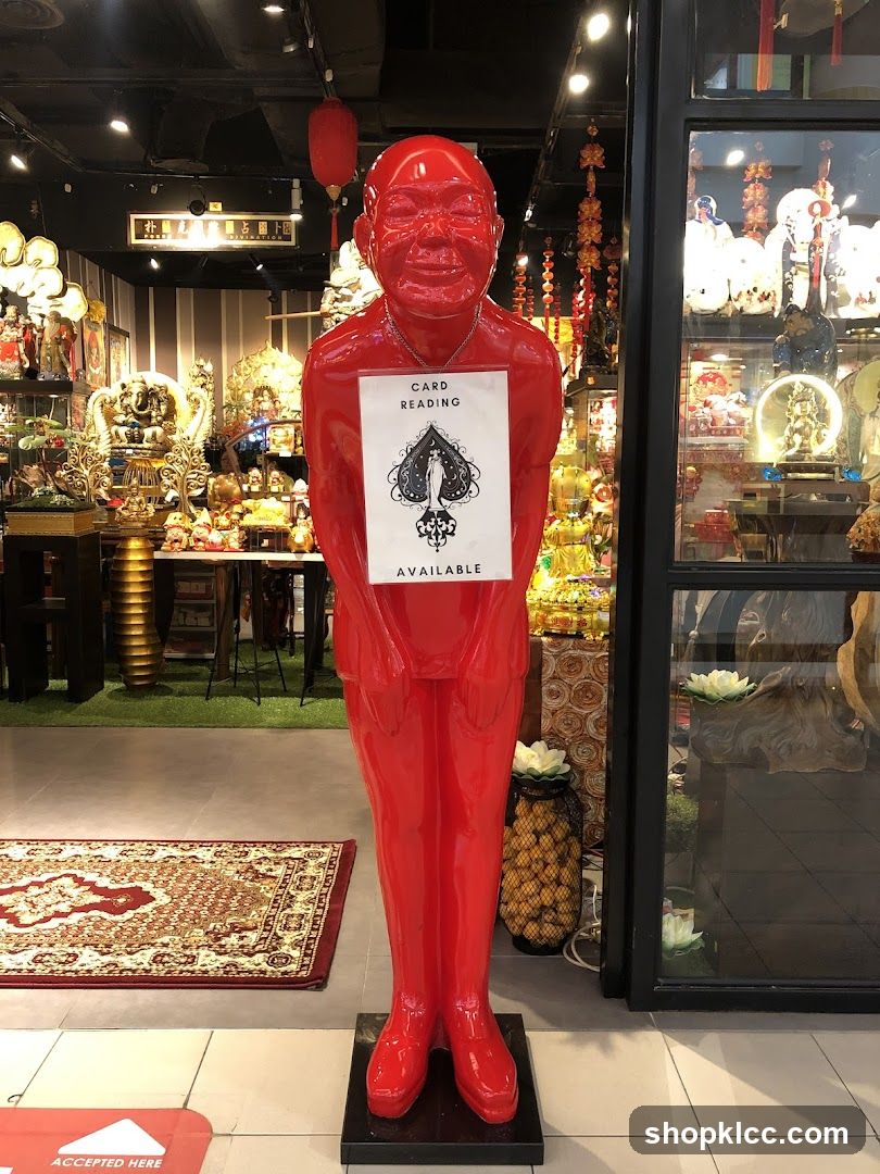Red Statue with Card Reading Sign