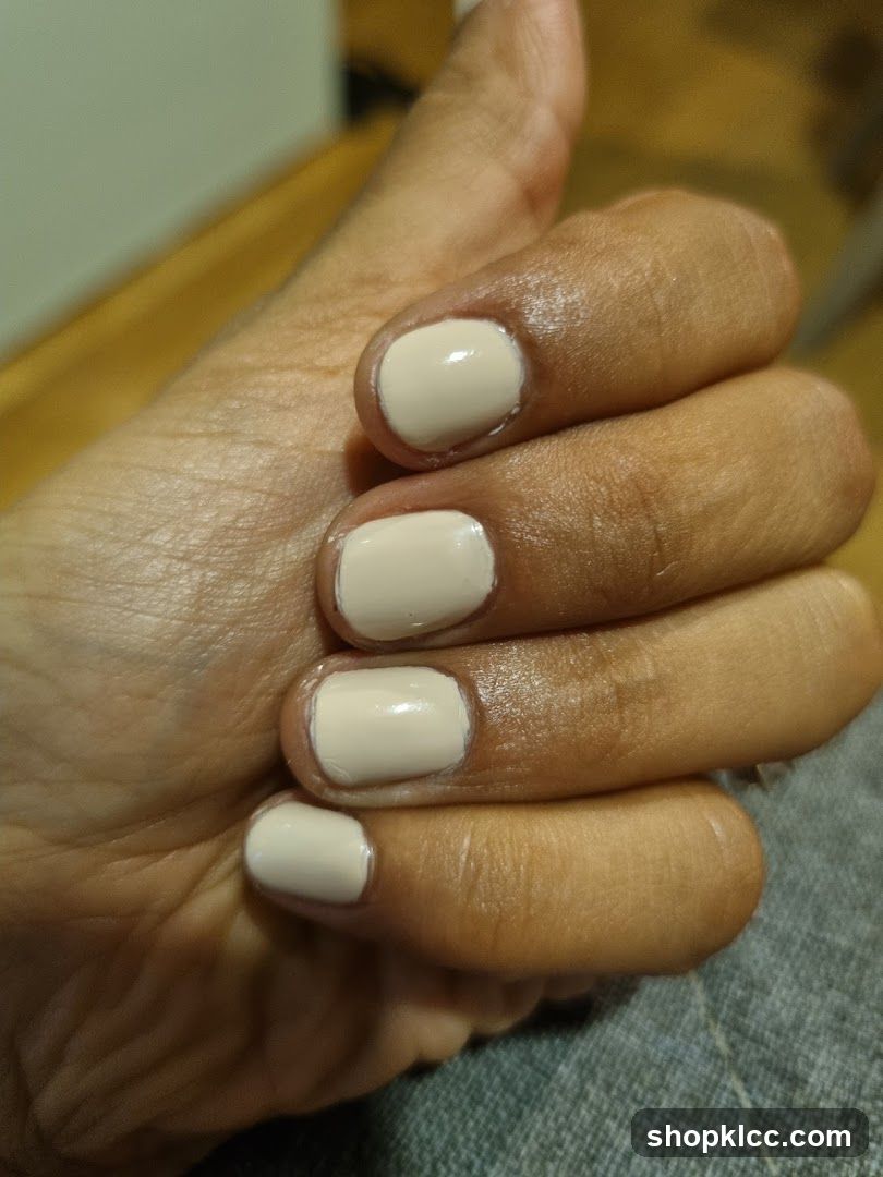 Close-up of a hand with light beige nail polish