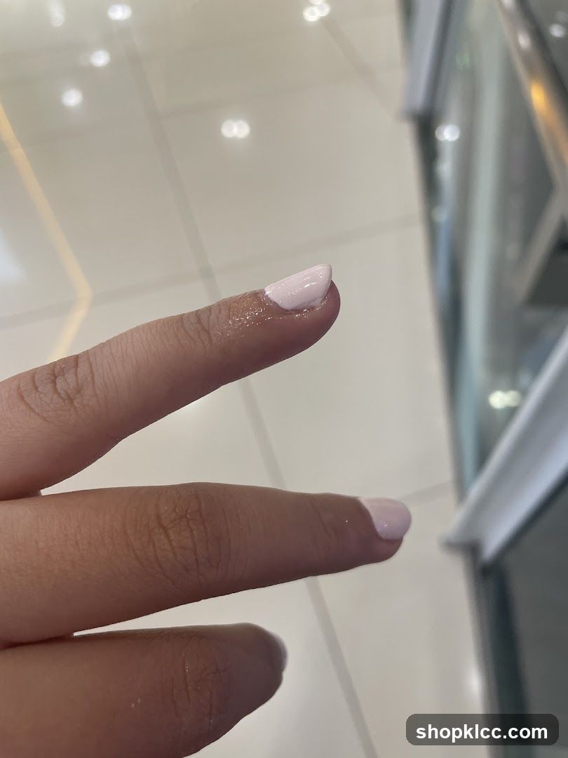 Close-up of a hand with light pink nail polish