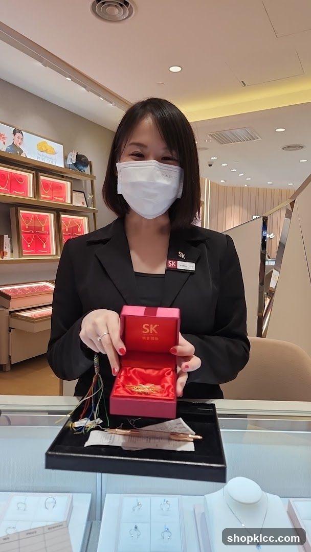 Jewelry Store Employee Presenting a Gold Brooch