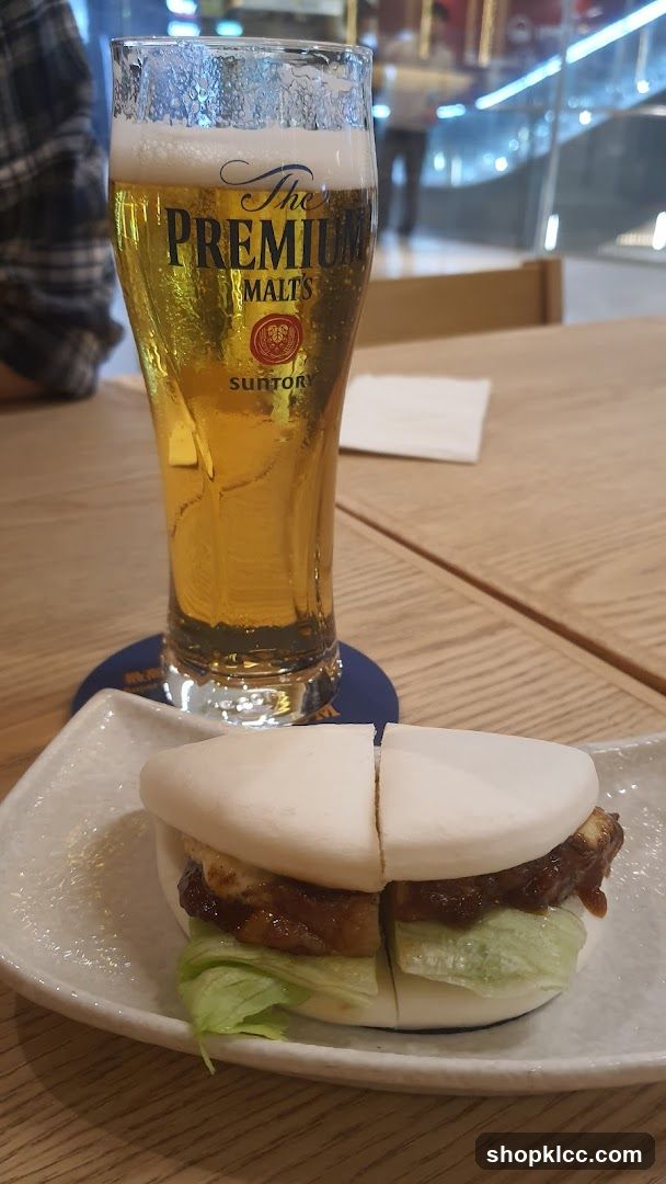 Beer and Sandwich on Wooden Table