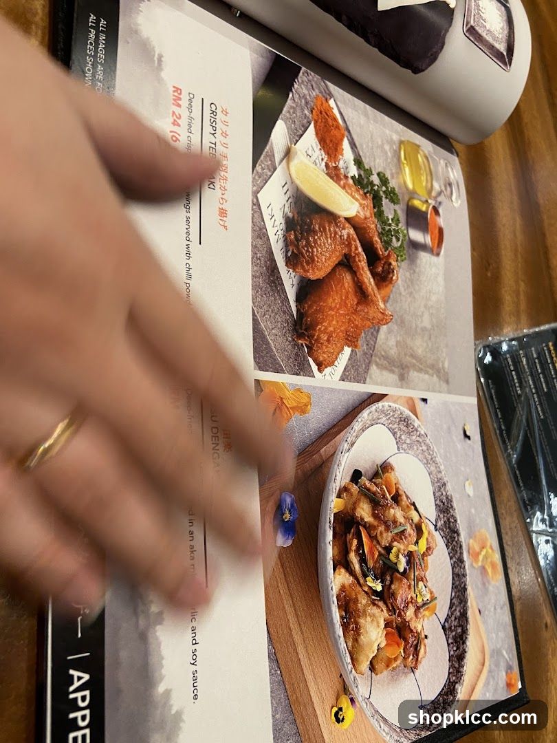 Hand holding a menu with food images