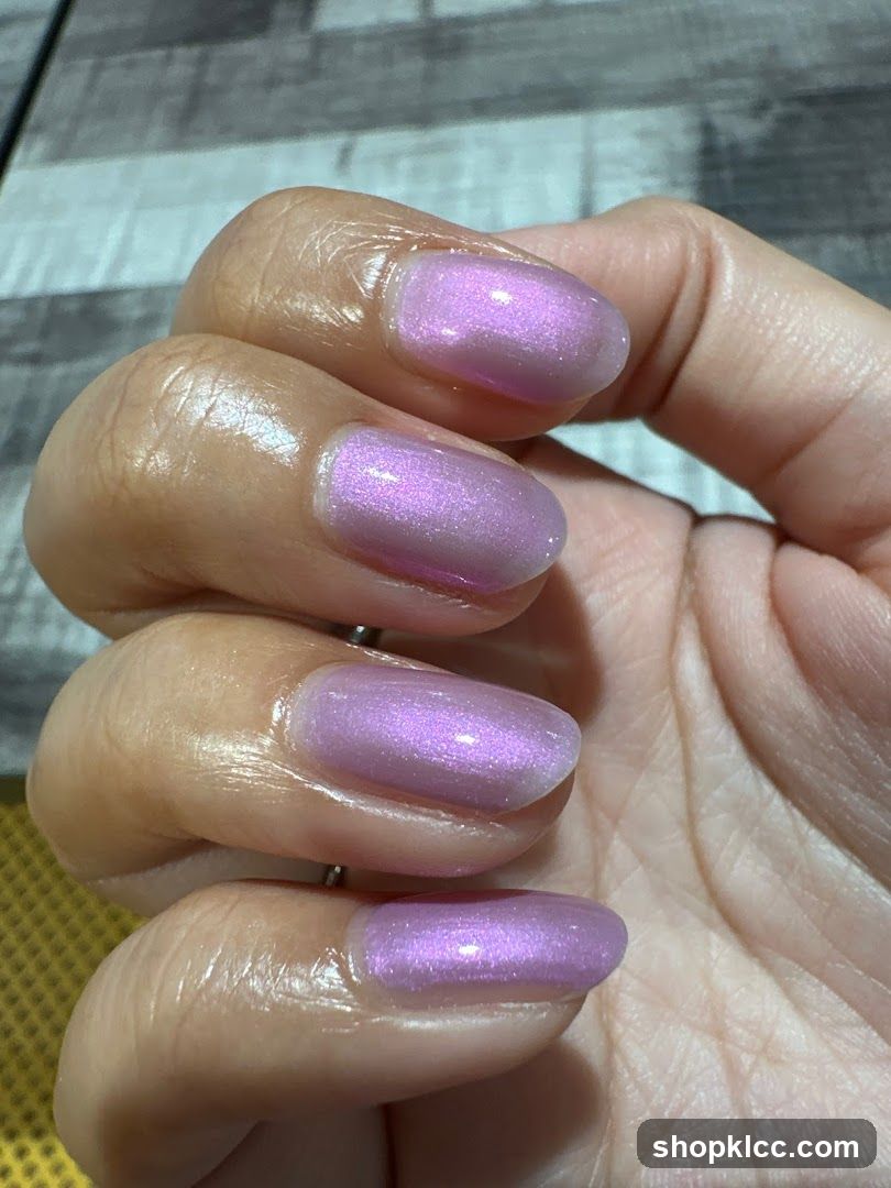 Close-up of a hand with lavender-colored nails