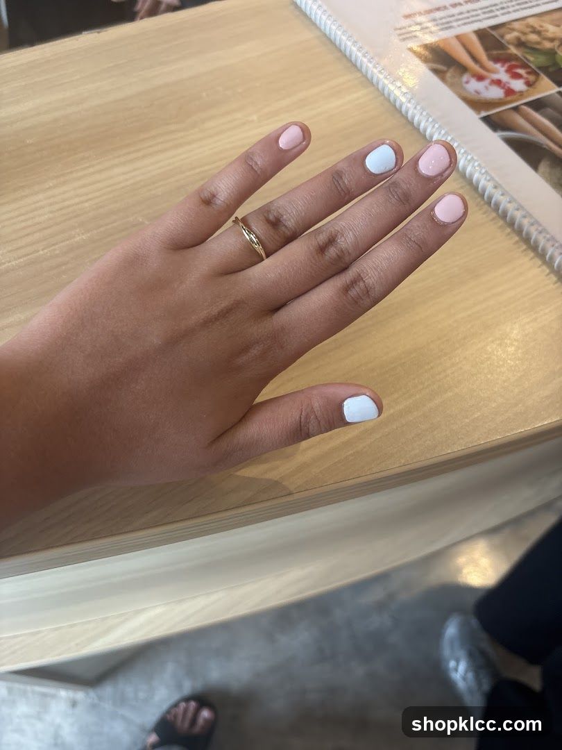 Hand with painted nails on a table