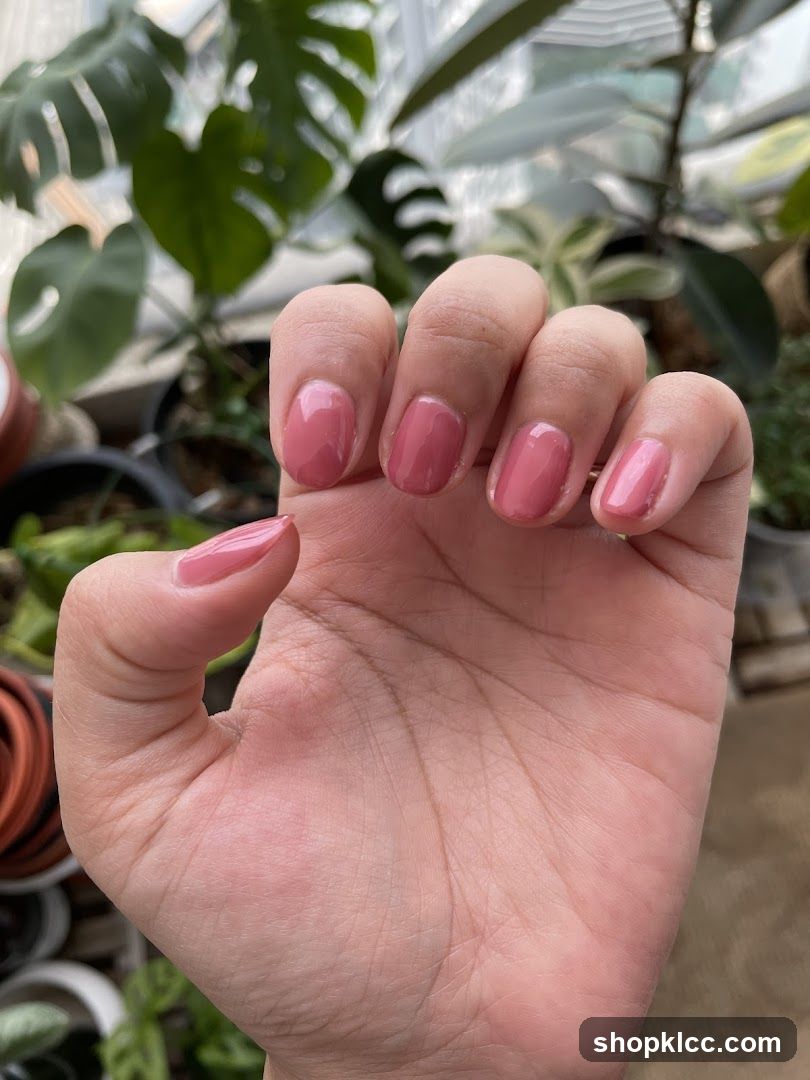 Close-up of a hand with pink nail polish