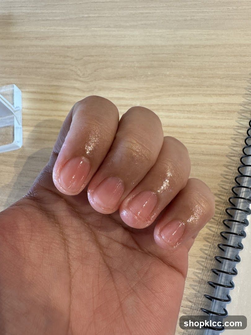 Hand with clear nail polish