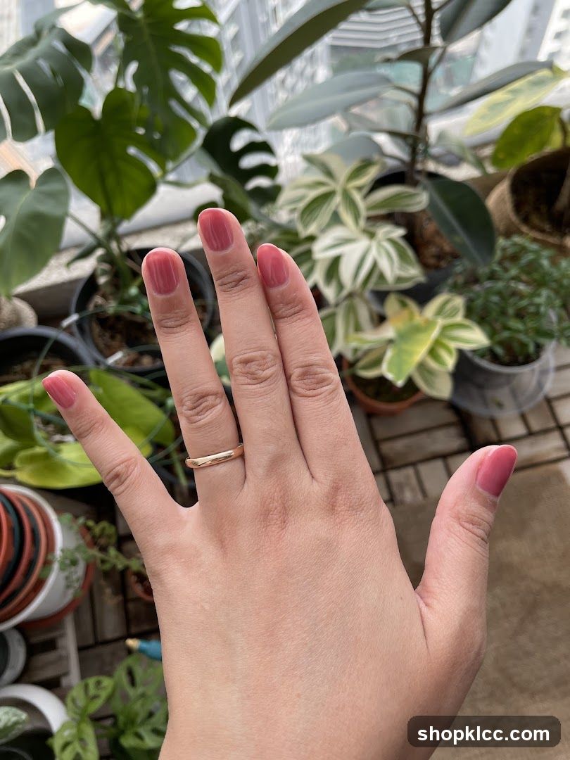 Hand with Ring and Pink Nail Polish