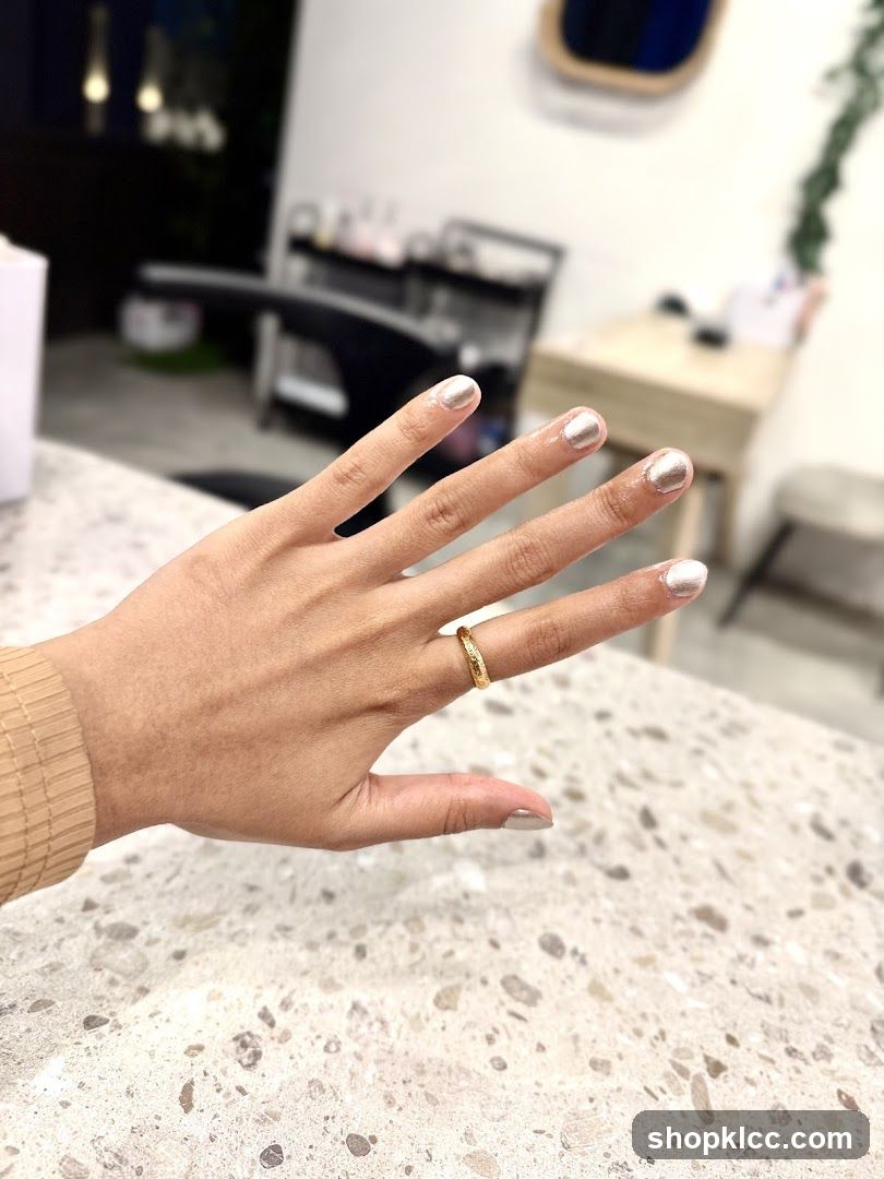 Woman's hand with metallic nail polish
