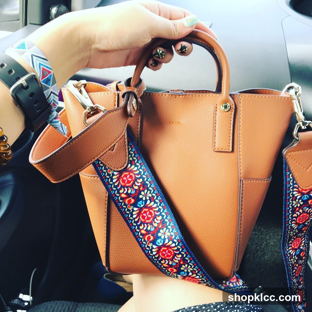 Woman Holding a Brown Handbag