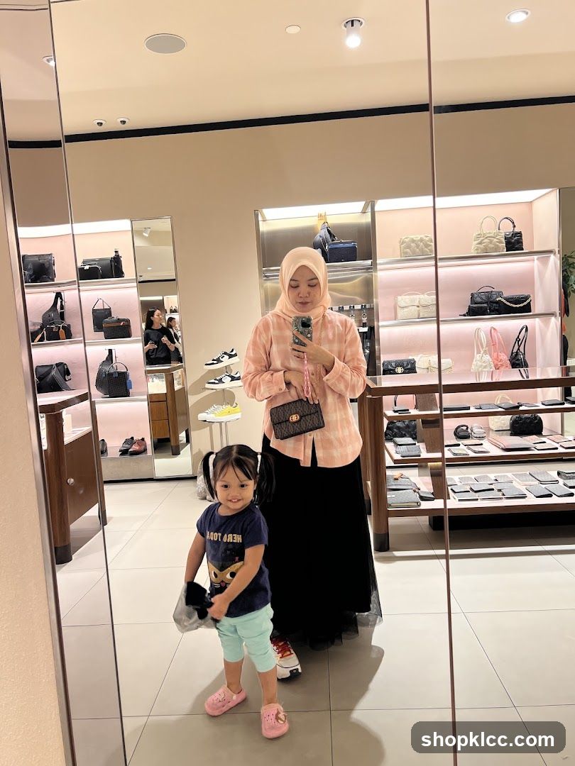Woman and child taking a mirror selfie in a store
