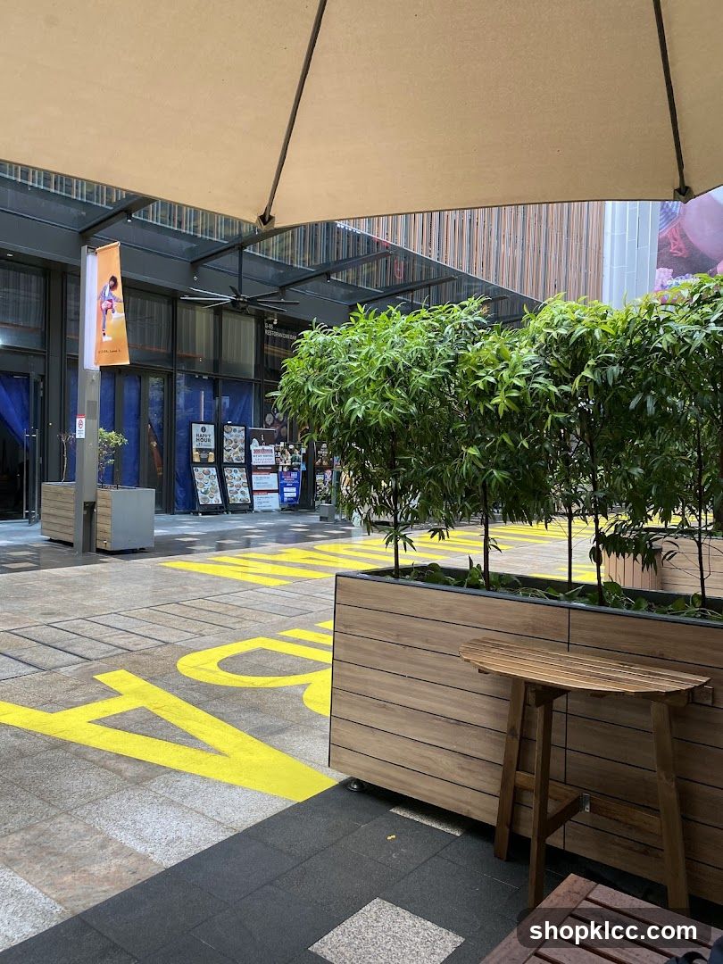 Outdoor seating area with planters and storefront entrance