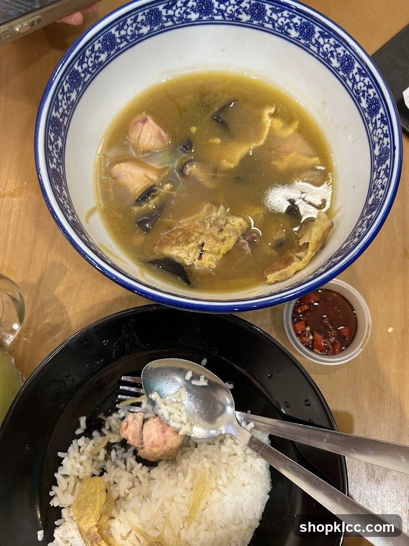 Bowl of soup with rice and chili sauce