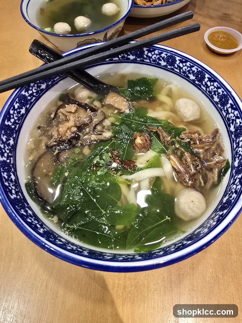 Bowl of Noodle Soup with Meatballs and Greens