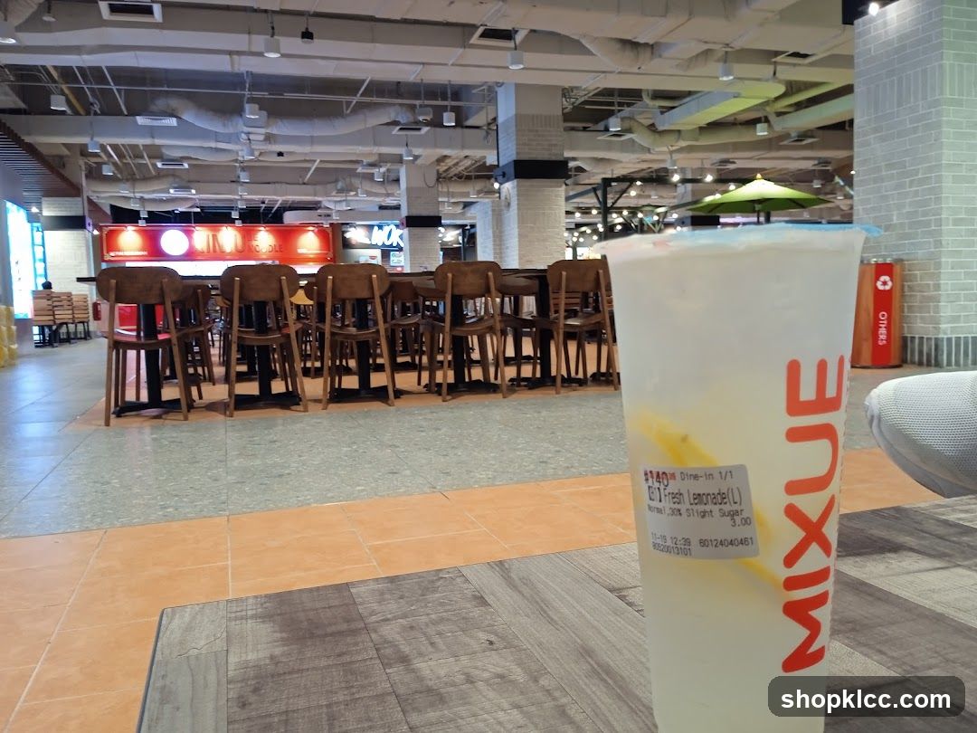 Drink with food court in background