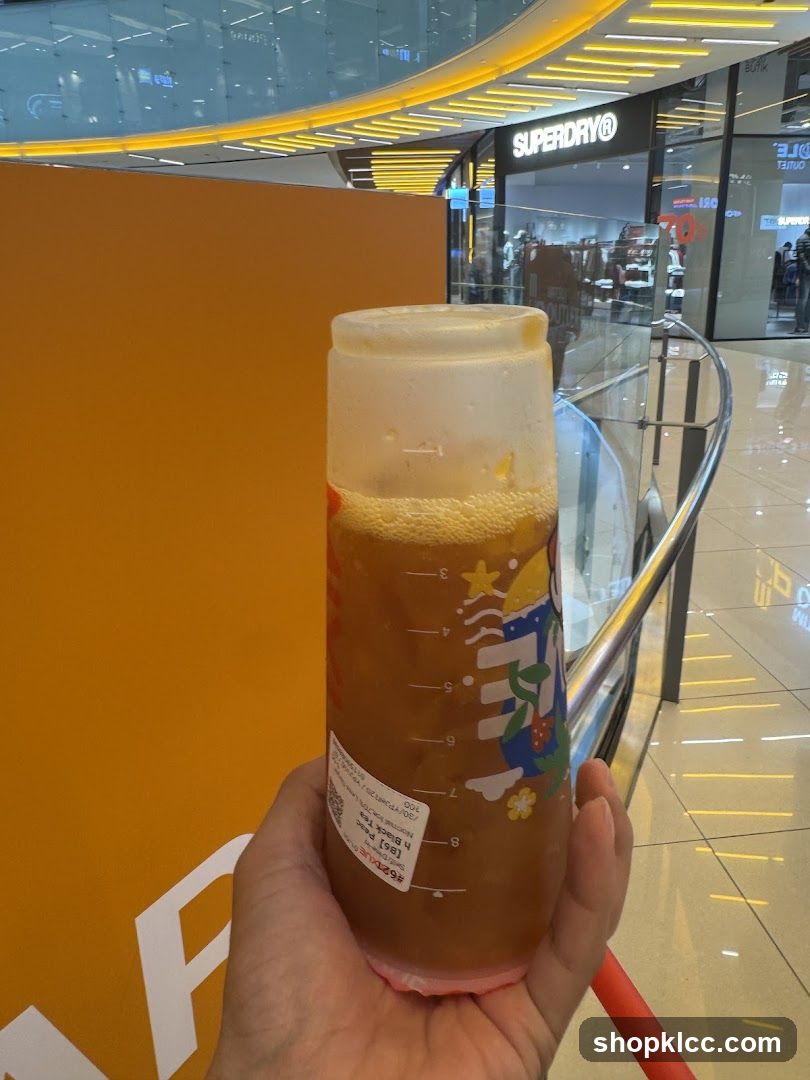 Beverage in a cup with store in background