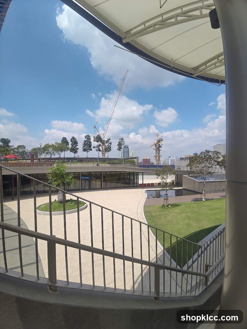Outdoor plaza with construction cranes in the background