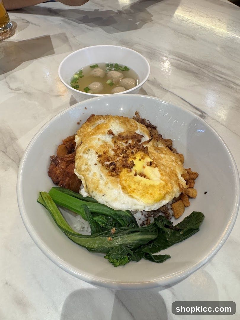 Rice bowl with fried egg and side soup