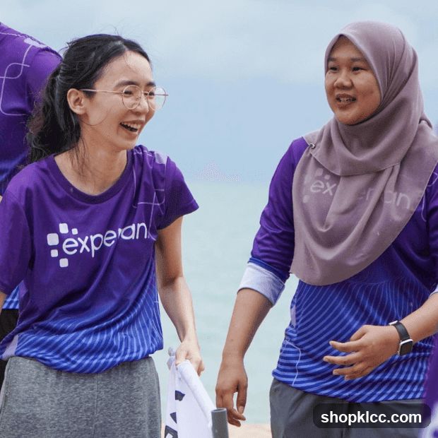 Two women in purple shirts with a logo