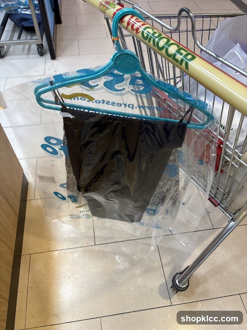Black garment on hanger in plastic bag