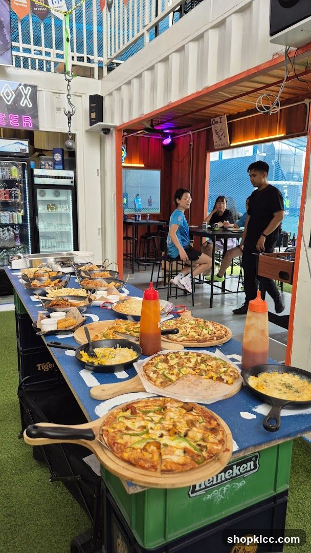 Food Display Table with Pizzas and Sides