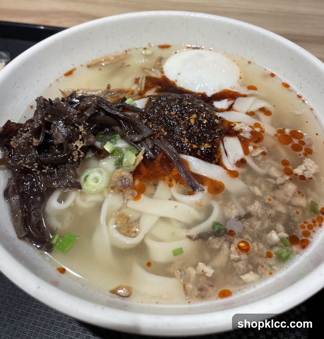 Bowl of Noodle Soup with Egg and Oil