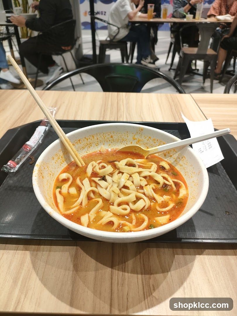 Bowl of Noodles with Chopsticks and Spoon