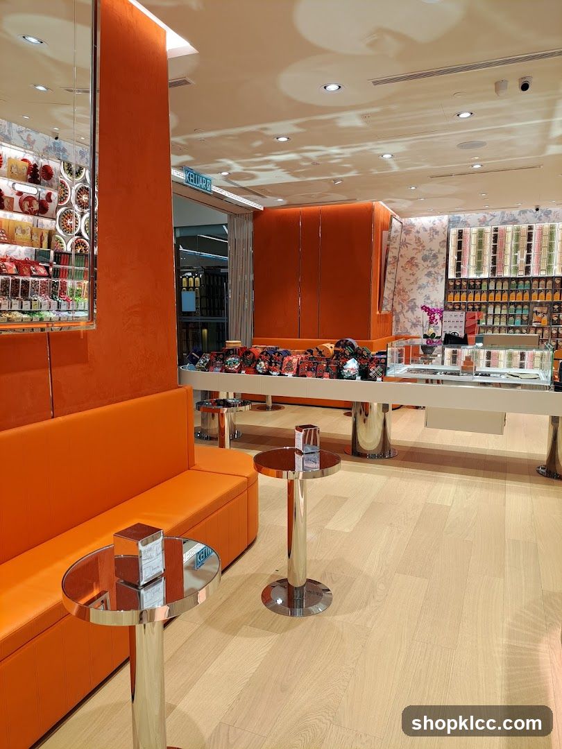 Interior of a brightly lit store with orange seating and display shelves.