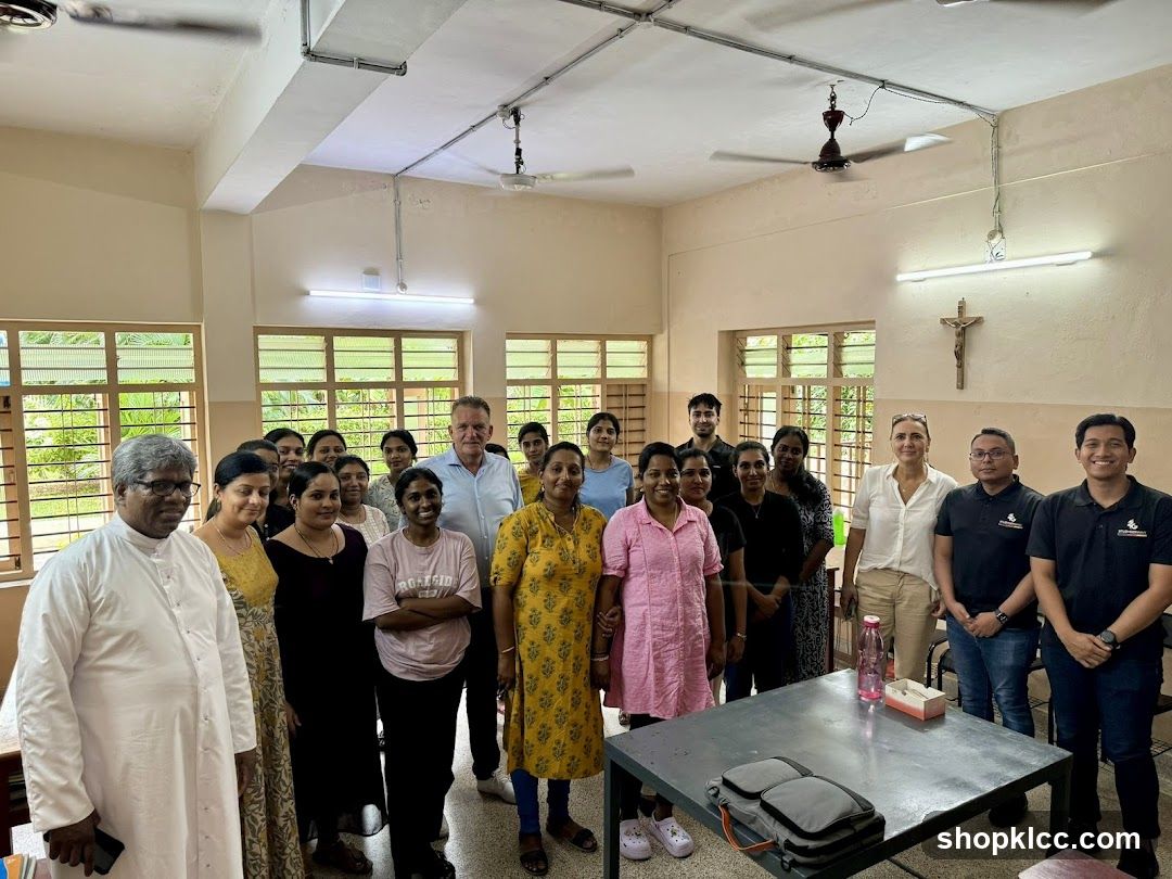 Group photo in a room with windows and ceiling fans