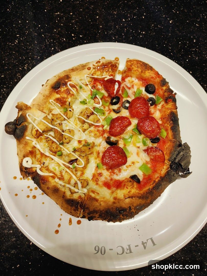 Pizza with mixed toppings on a white plate