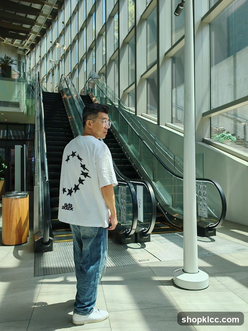 Man in White T-Shirt Standing Near Escalator