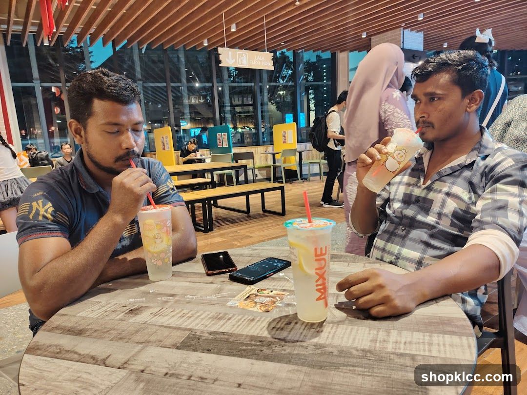 Two men drinking at a cafe table