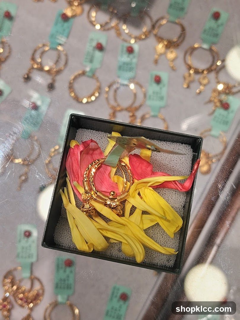 Gold Earrings Displayed with Flower Petals