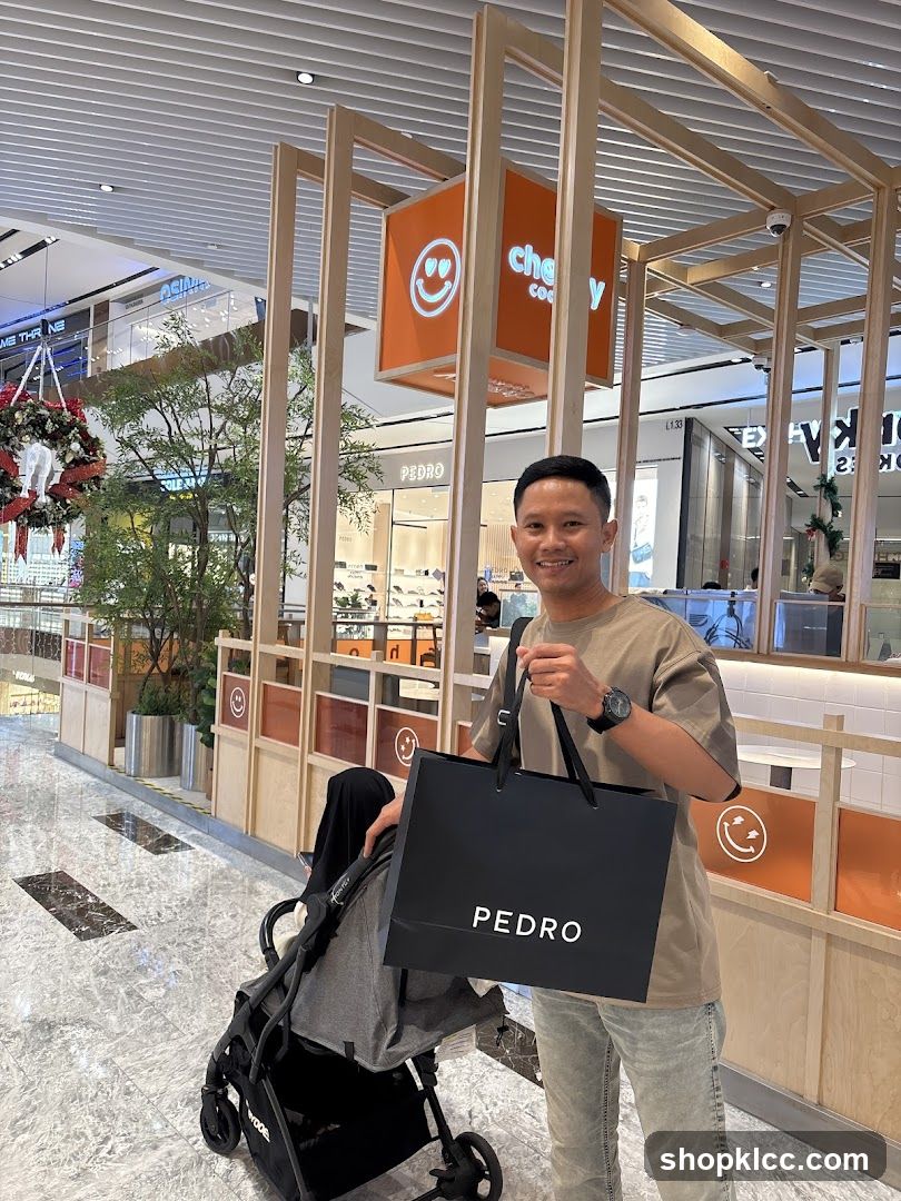 Man holding a shopping bag in a mall