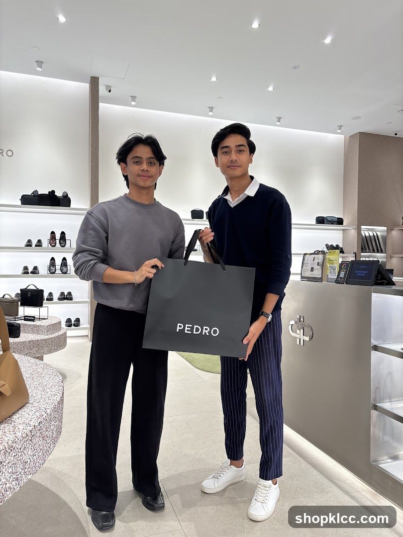 Two young men holding a shopping bag