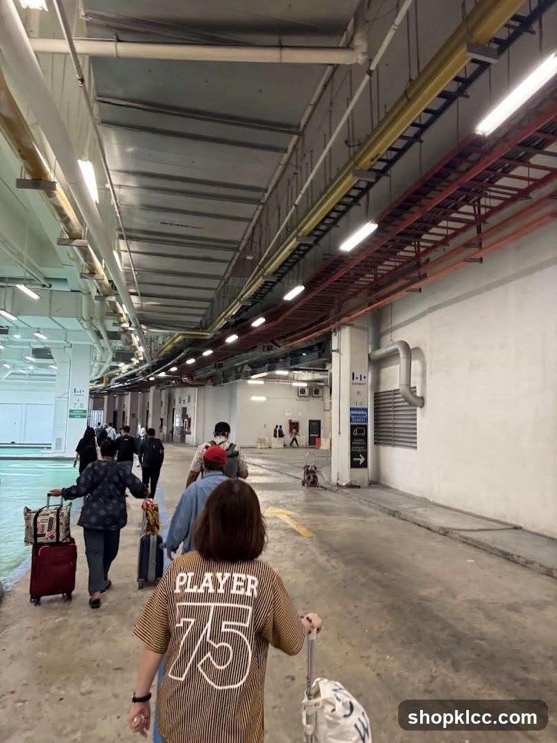 Travelers with luggage in an indoor corridor