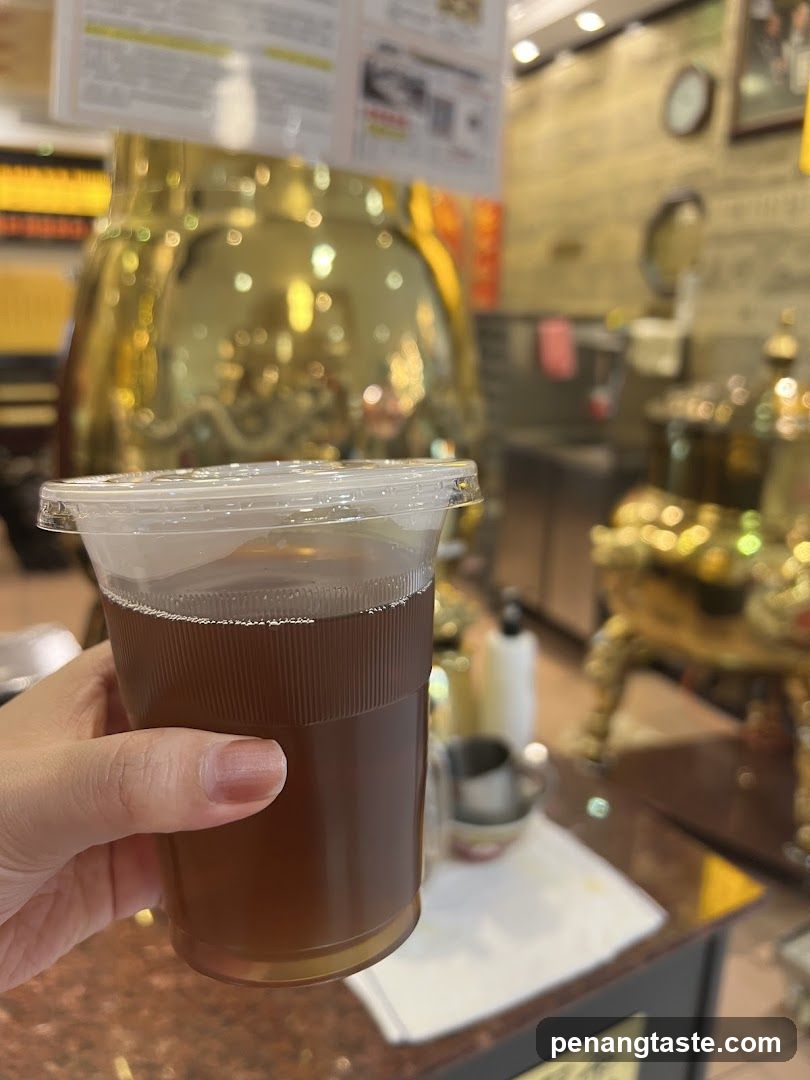 Hand holding a cup of iced tea in a shop