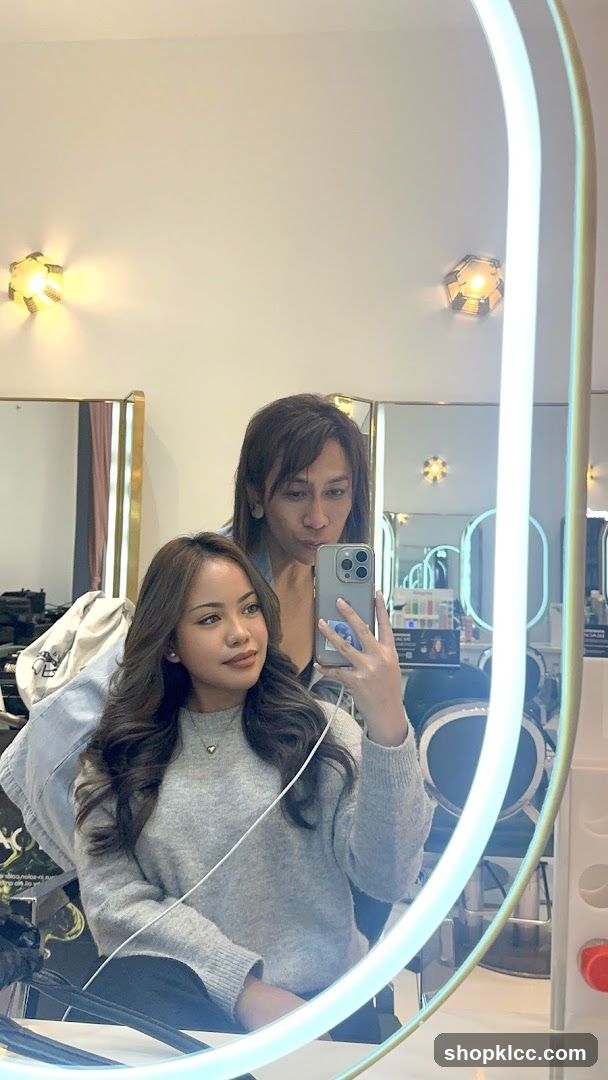Two people taking a selfie in a salon