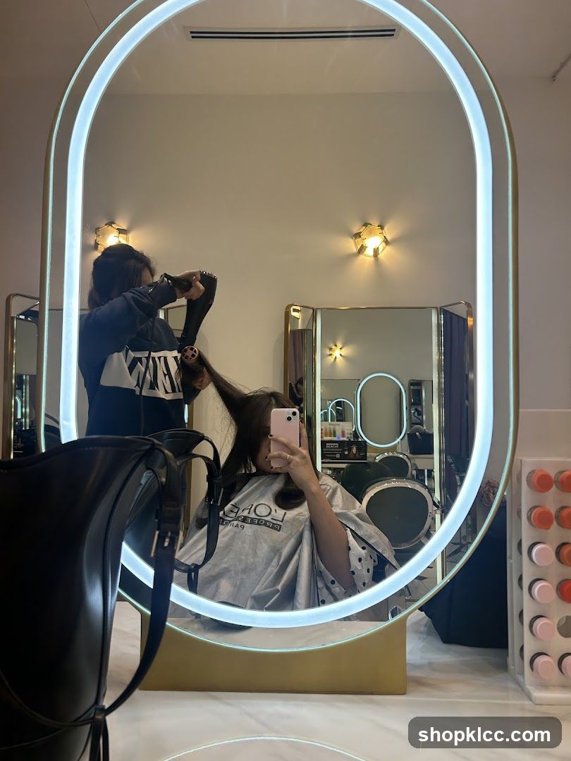 Hairdresser drying client's hair