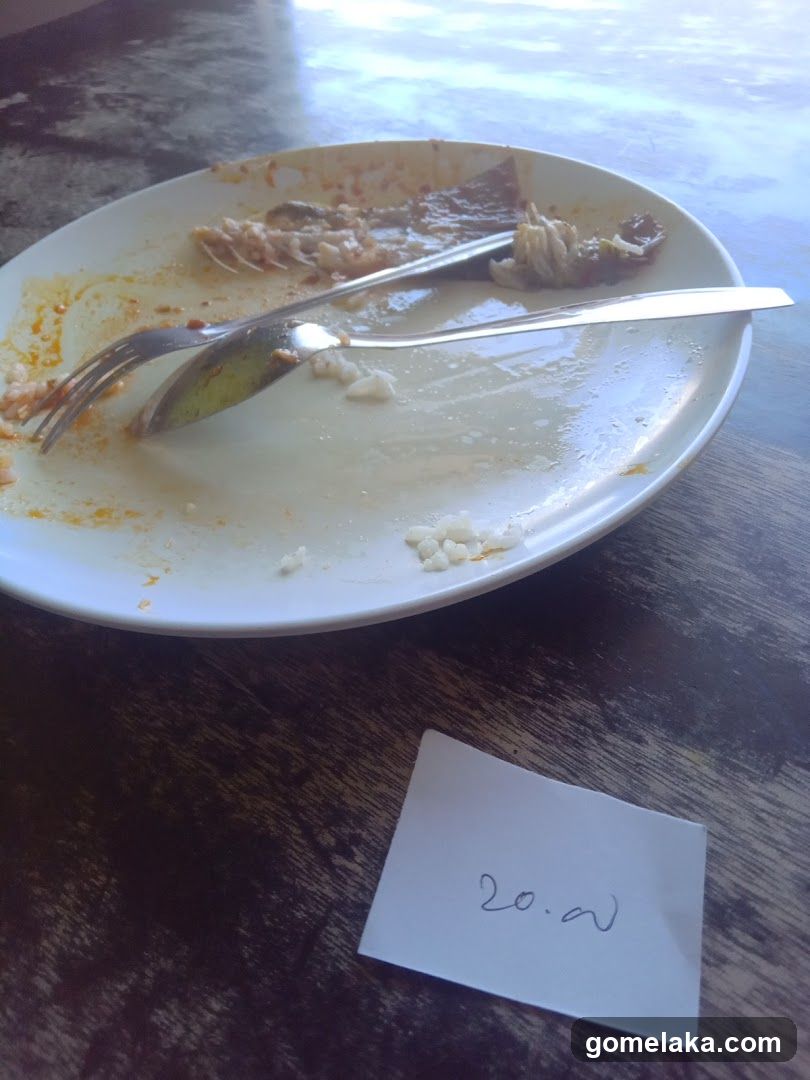 Eaten Plate with Utensils on Table