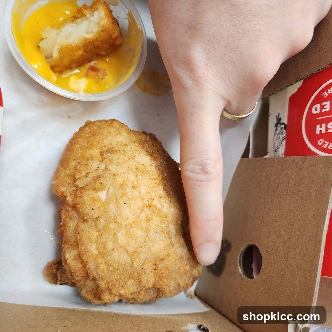 Fried chicken and potato bites with cheese sauce