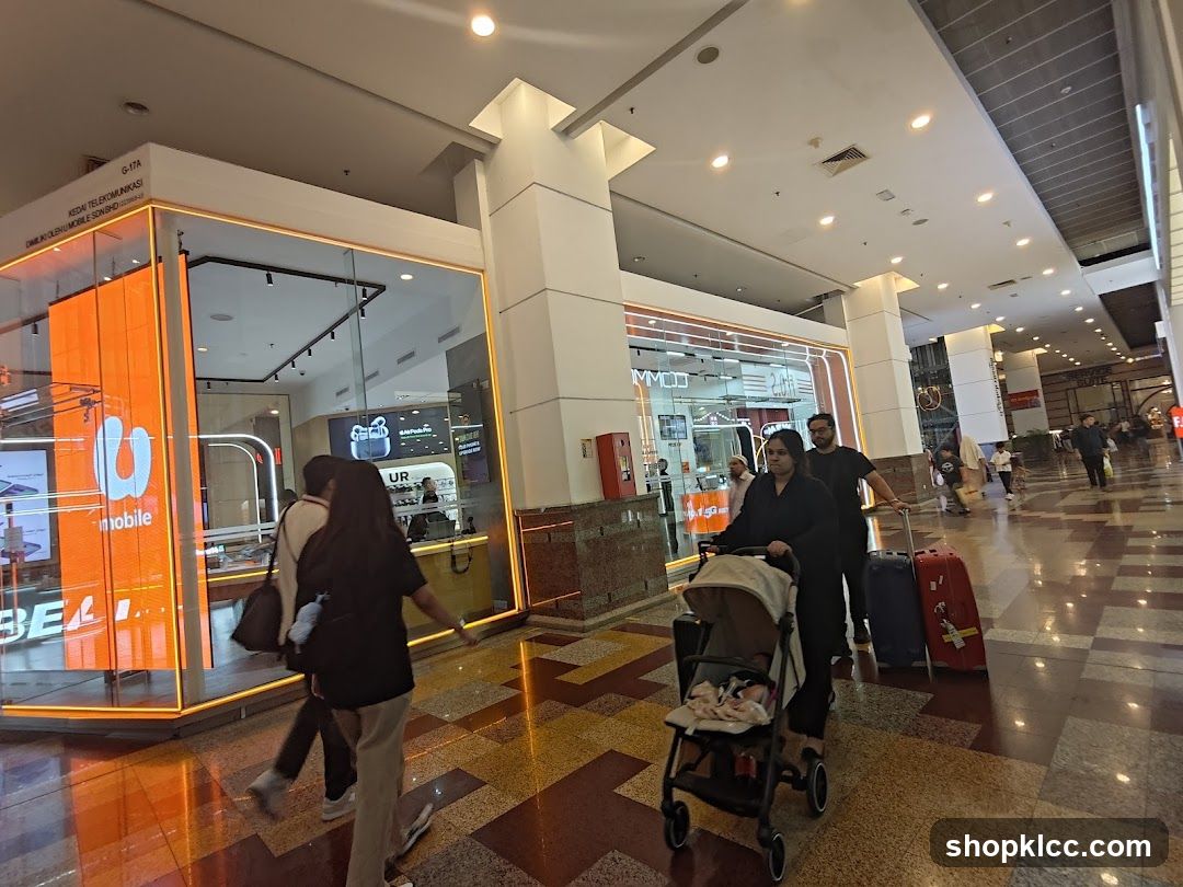 People walking in a mall with a mobile store