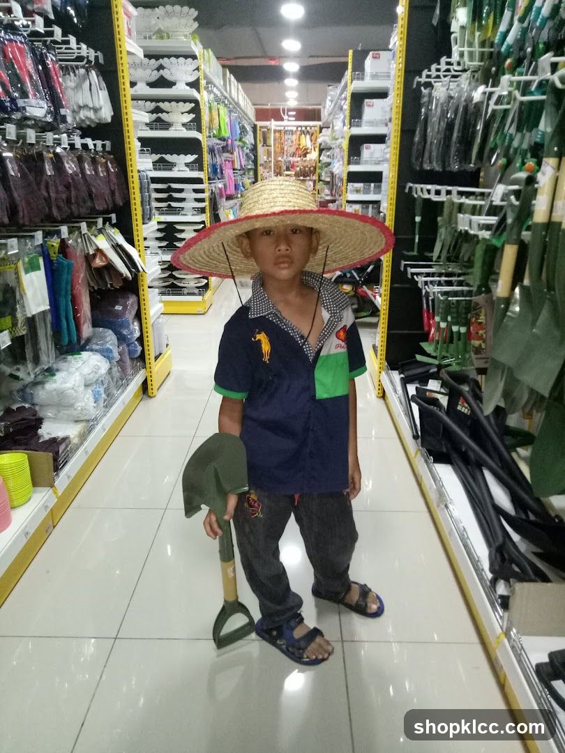 Boy in a straw hat holding a shovel