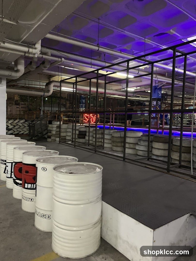 Indoor racing venue with barrels and tires