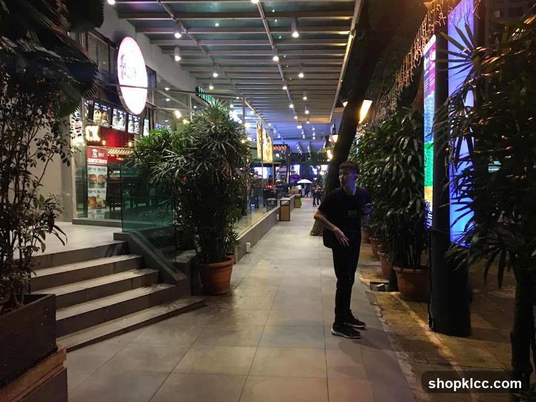 Nighttime street scene with a man and a restaurant storefront