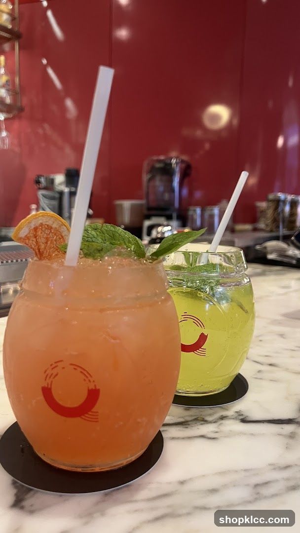 Two colorful cocktails on a marble countertop