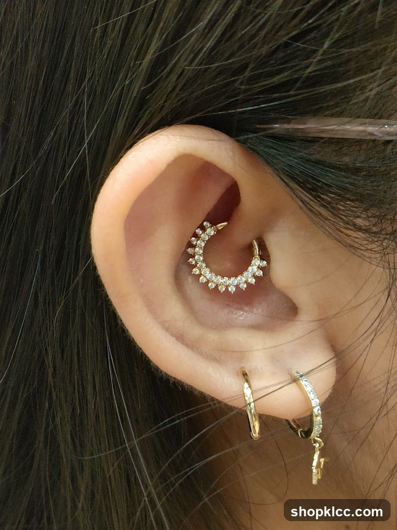 Close-up of a woman's ear with multiple piercings and jewelry